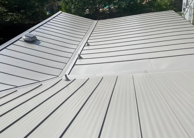 Solar attic fan installed on a metal roof for Roof Ventilation in Seymour